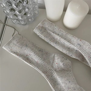 Detail of light gray ribbed cotton mid-calf socks with colorful speckle yarn texture