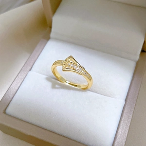 Detailed view of adjustable golden ginkgo ring with sparkling zircons in a jewelry box