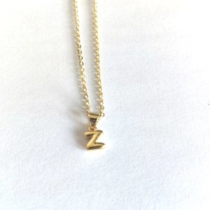 Detailed view of a gold-plated letter Z pendant necklace on a clean white background