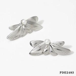 Detail of silver butterfly earrings with pearlescent center and fine metal texture