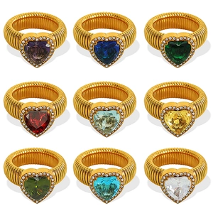 Gold ribbed heart rings set with colorful central stones and small surrounding crystals