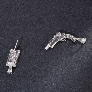 Vintage punk style titanium steel tank and revolver pendant charms for men on black background