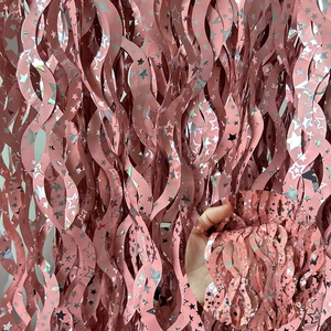 Close-up of pink wavy fringe curtain with shiny silver star pattern for party backdrop
