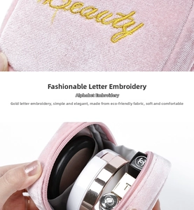 Detail of pink velvet makeup bag showing gold Beauty embroidery and soft fabric texture