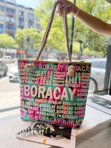 Detail of tropical floral canvas tote with Boracay lettering and thick hemp rope handles