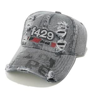 Detail of distressed grey denim baseball cap with f429 embroidery and ripped texture