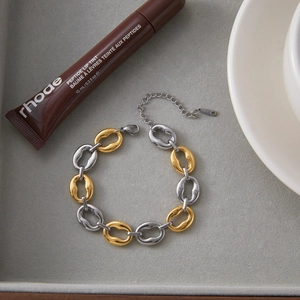 Detailed close-up of two-tone interlocking steel links with S-STEEL engraved hallmark