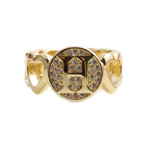 Detailed macro view of heart cutout ring band with gold finish and zircon stones