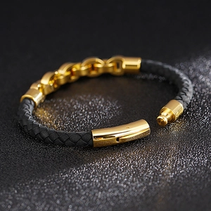 Detail of black braided leather bracelet with gold-plated stainless steel magnetic clasp