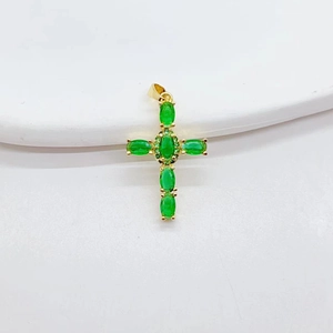 Gothic gold cross necklace featuring green emerald-like gemstones in a vintage punk style