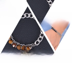 Detail of tiger eye stone beads and silver stainless steel Cuban chain bracelet
