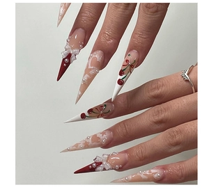 Detailed stiletto nails with 3D bows, pearls, and red cherry hand-painted nail art designs