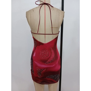 Detail of red rose floral print dress featuring sparkling rhinestones and open back