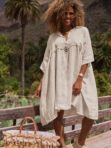 Detail of bohemian cotton linen shirt dress featuring V-neck and pleats on shoulders