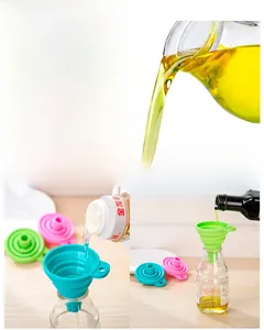 Close-up of collapsible silicone kitchen funnel being used for oil liquid transfer