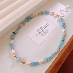 Elegant aquamarine and freshwater pearl necklace with gold accents and extender chain