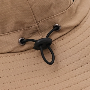 Detail of khaki ripstop fabric on outdoor sun hat with adjustable drawstring and metal eyelet