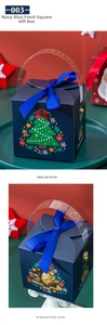 Detail of navy Christmas gift box with blue ribbon bow and festive hollow window design