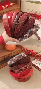 Close-up of vintage red hairbands in leather, knit, and wool materials with bear decor
