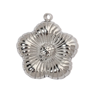 Macro detail of a silver five-petal flower pendant with textured surface and ring hook
