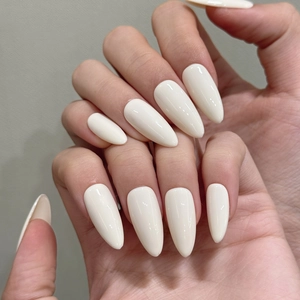 Detailed view of long almond cream white press-on nails with high-gloss finish on hands