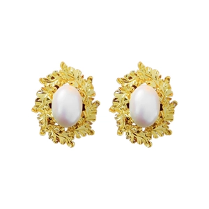 Vintage gold leaf earrings with white pearl center against a clean white background