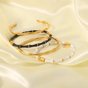 Bamboo style stainless steel bangles in gold with black and white enamel accents