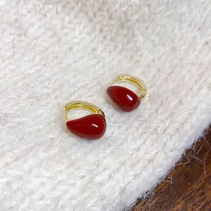 Minimalist gold hoop earrings featuring bright red waterdrop oil-dripping charms