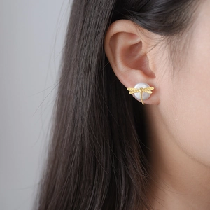 Creative S925 silver dragonfly stud earrings with white pearl detail on model