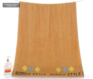 Close-up of thick coffee cotton towel with Nordic Style diamond pattern and text details