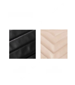 Detail of V-quilted faux leather texture in black and apricot with clean stitching