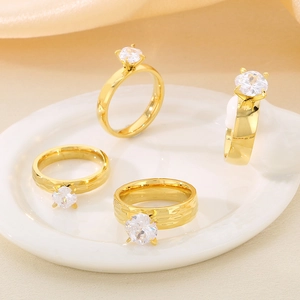 Polished 18K gold-plated titanium rings with zircon stones set on a ceramic plate