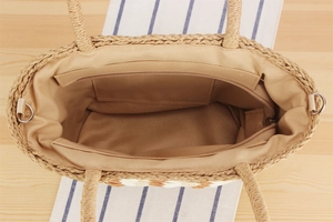Detail of woven tote bag featuring spacious fabric lining and a secure zipper inner pocket