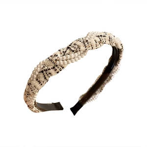 Elegant twisted tweed headband with faux pearl accents in classic black and white