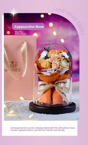 Detail of soap rose flower bouquet in a glass dome with a stylish gift bag