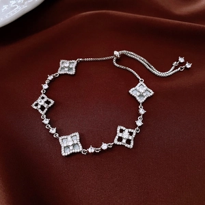 Detailed macro view of the silver flower pendants with mother of pearl and cubic zirconia