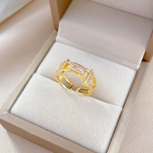 Luxurious gold zircon ring with rectangular stone in a beige velvet jewelry box