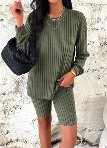 Detailed texture of olive green ribbed knit fabric on a casual long sleeve top and shorts set