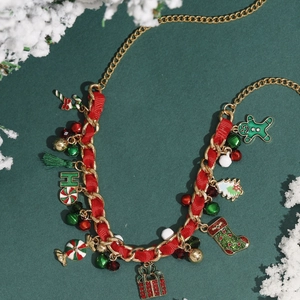 Christmas necklace with gold chain and red ribbon featuring festive holiday pendants