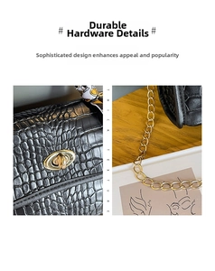 Close-up of black crocodile pattern leather bag with golden oval lock and silk scarf detail