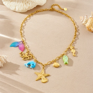 Cute Korean ocean necklace with acrylic mermaid tail, starfish, and shell pendants on beach sand