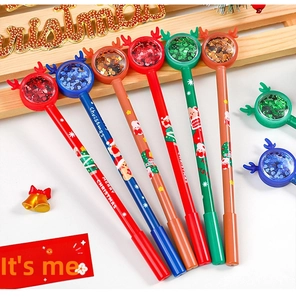 Close-up of Christmas pens with reindeer horns, sequins and festive Merry Christmas prints