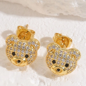 Macro detail of gold-plated bear stud earrings with sparkling pave-set cubic zirconia