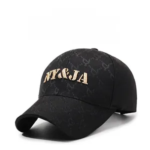 Close-up of black baseball cap featuring 3D gold NY and JA embroidery and texture