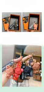 Close-up of geometric bear keychains with logo strap and premium gift box set