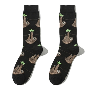 Detailed knit pattern of mid-calf socks featuring brown sloths on black fabric
