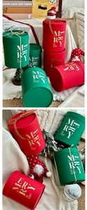 Detail of red and green round Christmas gift box with Merry Christmas typography