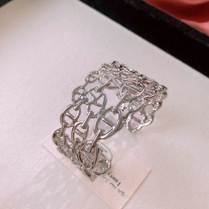 Macro shot of polished silver hollow pig nose link cuff bracelet with glossy finish