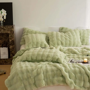 Close-up of luxury light green faux rabbit fur blanket with soft plush texture details