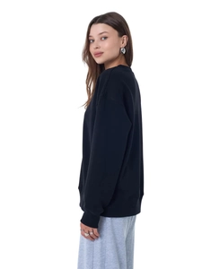 Side view of oversized black crewneck sweatshirt showing loose fit and soft fabric drape
